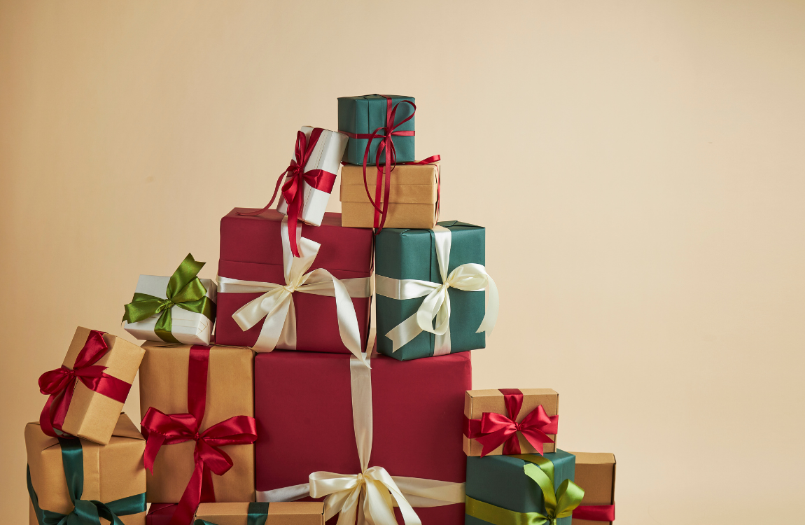 Stack of festively wrapped Tiseco gifts in classic Christmas colors (red and green), ideal holiday presents for the home.